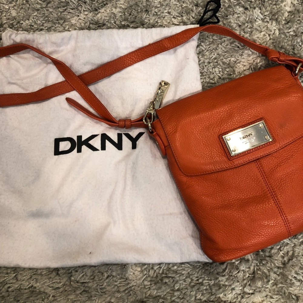 Orange DKNY crossbody bag with gold hardware